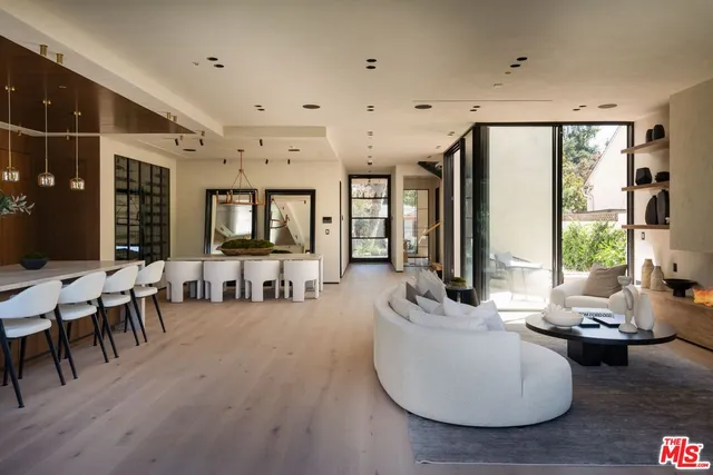 a living room with furniture and large windows