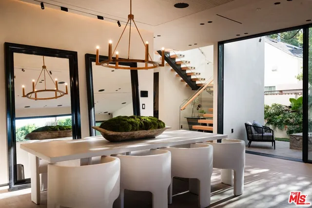 a dining room with furniture and a floor to ceiling window