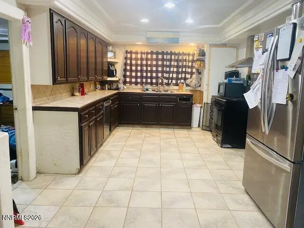 a kitchen with a sink cabinets and stainless steel appliances