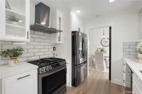 a kitchen with a stove a refrigerator and a cabinets