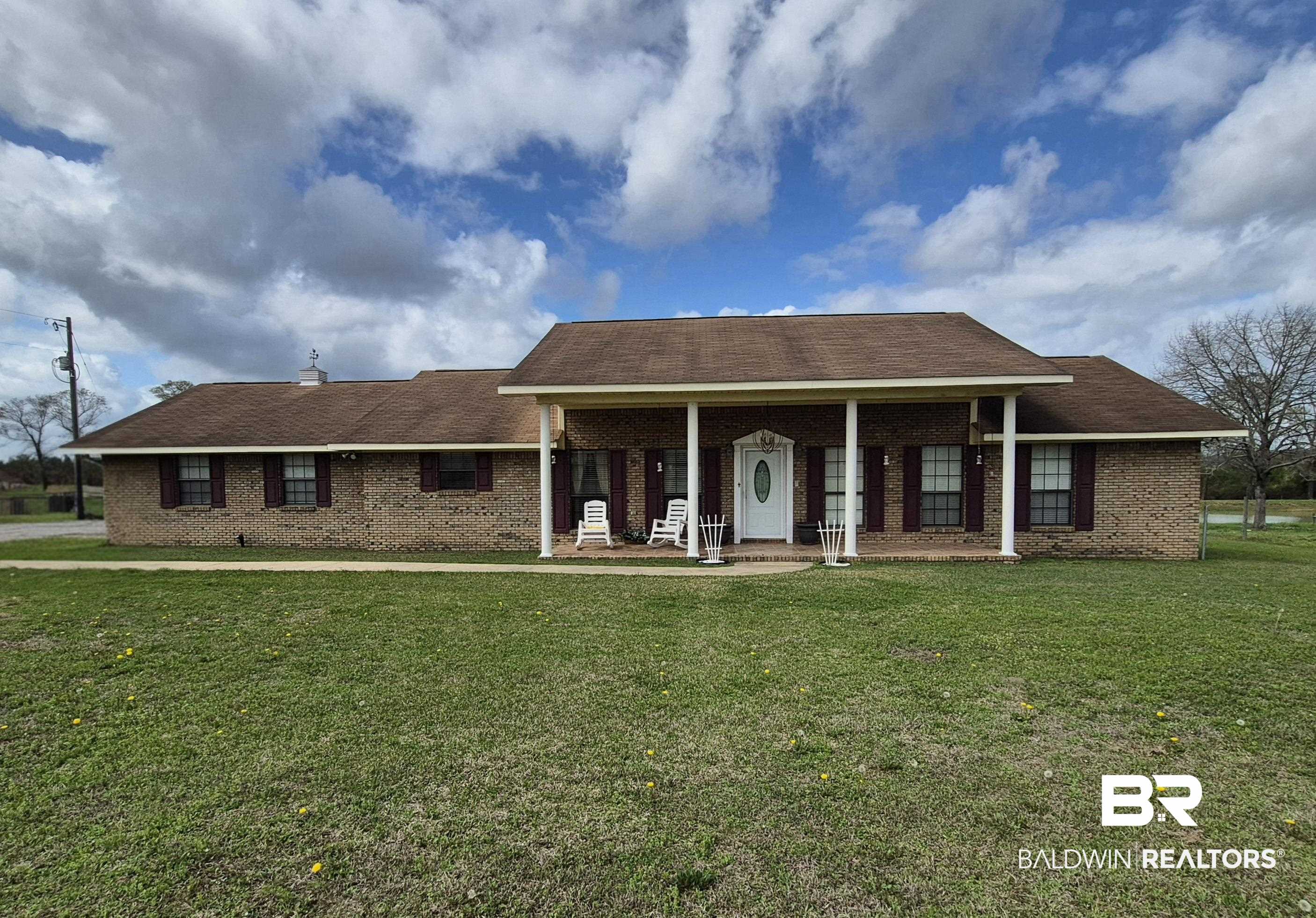 26635 Highway 41 Range, AL 36473 - Photo 1 of 74 View of front of home featuring a porch, brick siding, roof with shingles, and a front lawn