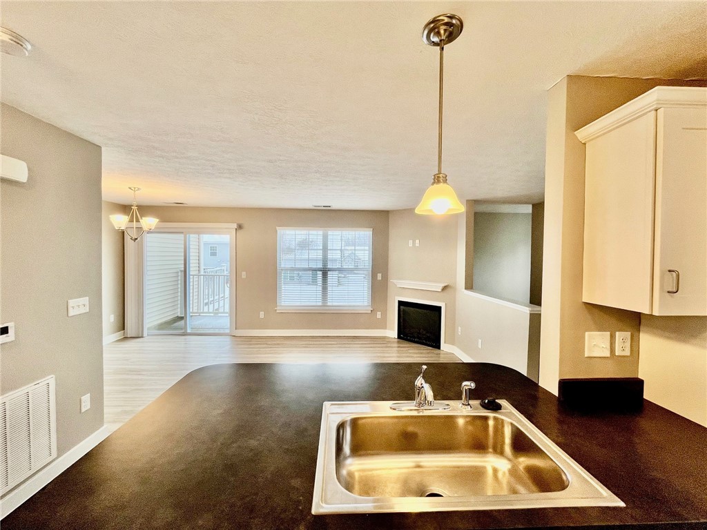 303 New Terrace Lane Rochester, NY 14624 - Photo 3 of 11 View from kitchen towards great room with fireplac