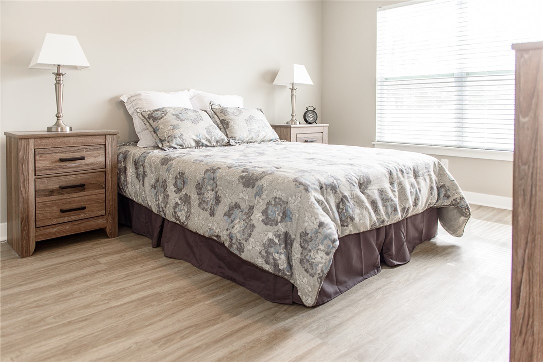 303 New Terrace Lane Rochester, NY 14624 - Photo 7 of 11 Typical bedroom with plank flooring & large window