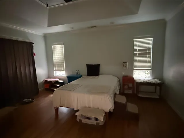a bedroom with a bed and a window