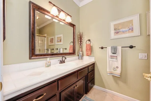 a bathroom with a sink vanity and a mirror