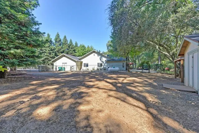 a view of house with street and trees