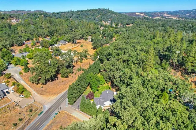an aerial view of a house with a yard