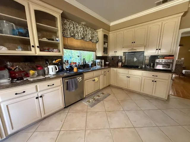 a kitchen with cabinets and window