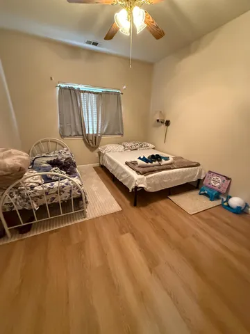 a bedroom with two beds and a chandelier