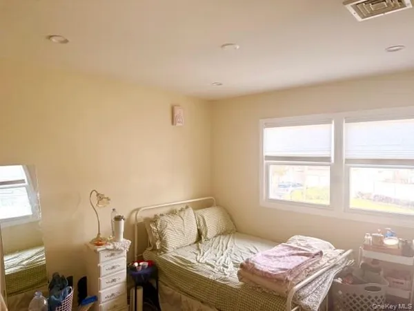 a bedroom with furniture and a window