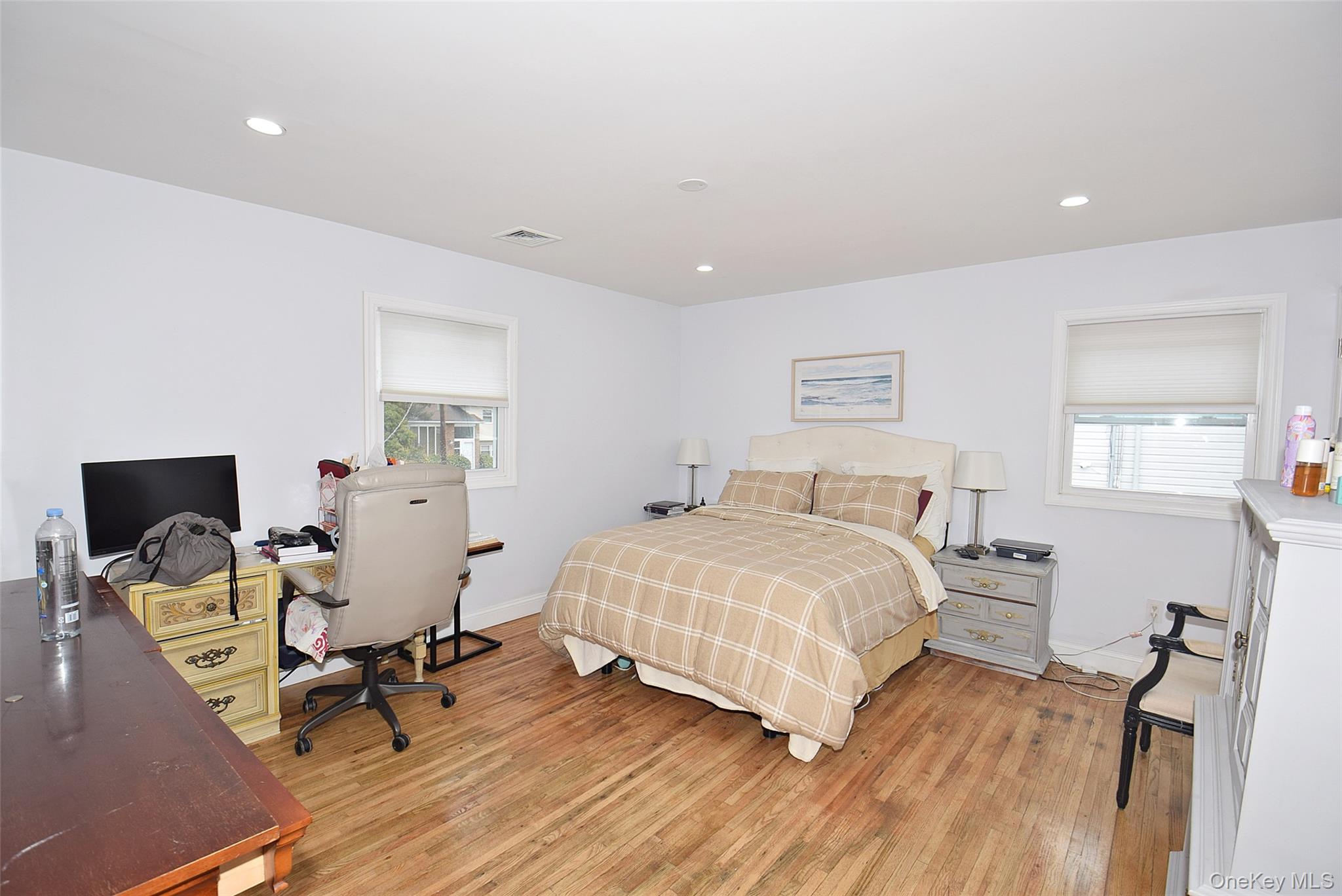 3029 Ann Street Baldwin, NY 11510 - Photo 18 of 26 a bedroom with a bed and wooden floor