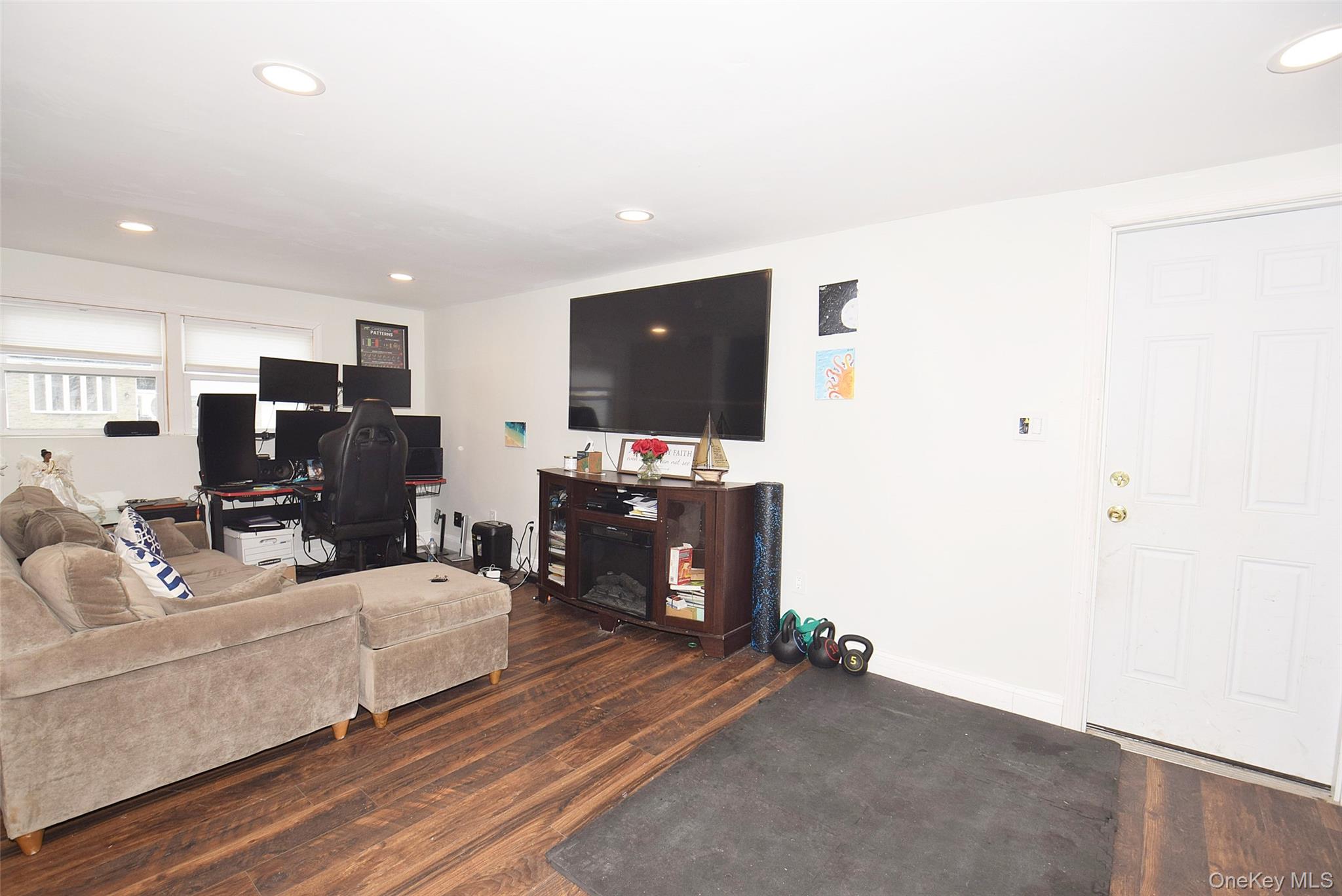 3029 Ann Street Baldwin, NY 11510 - Photo 20 of 26 a living room with furniture and a flat screen tv