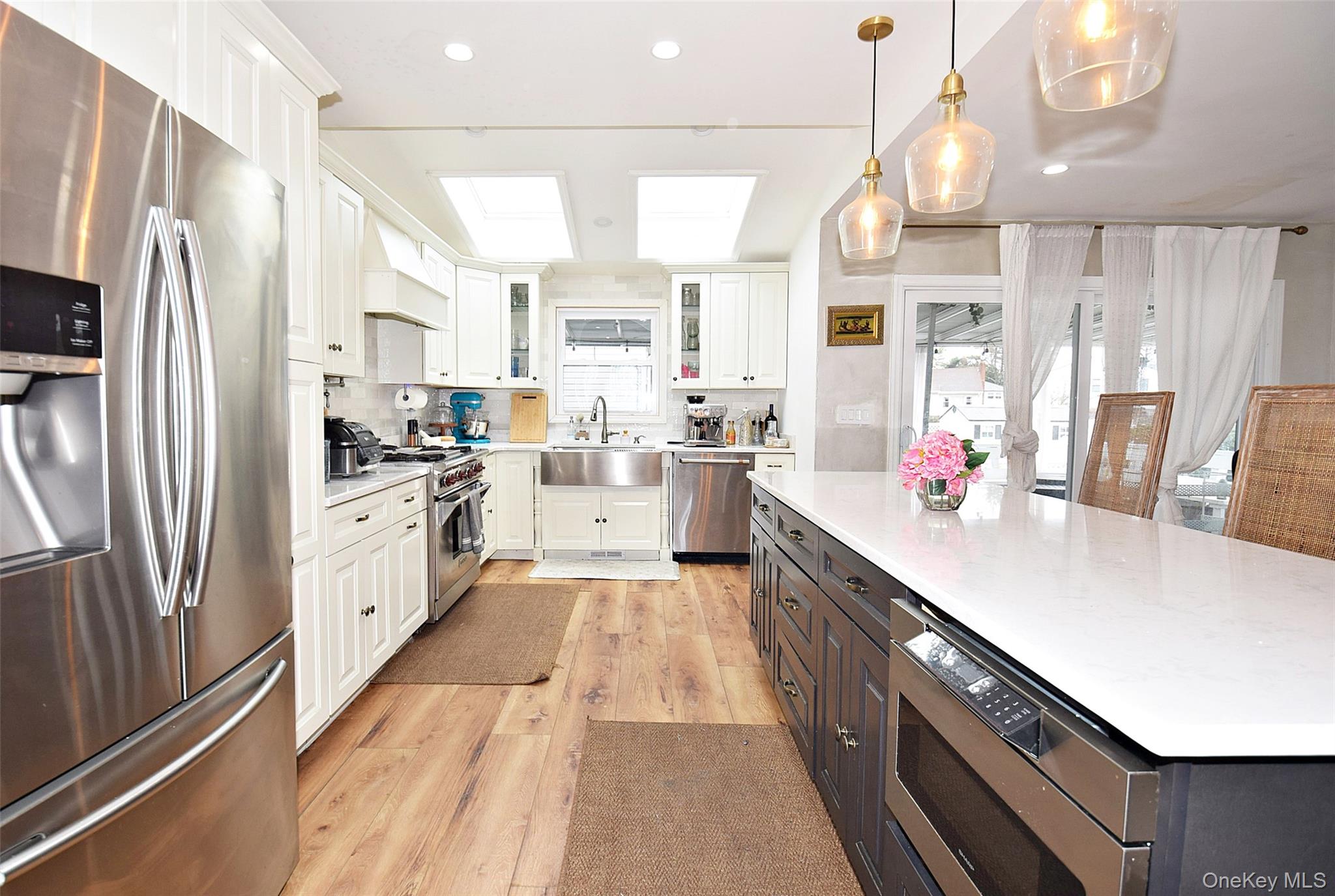 3029 Ann Street Baldwin, NY 11510 - Photo 8 of 26 a large kitchen with stainless steel appliances lots of counter space and wooden floor