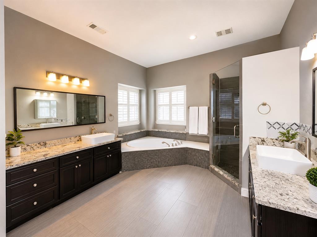6004 Ridgemore Drive Parker, TX 75002 - Photo 11 of 13 a large bathroom with a granite countertop double vanity sink a bathtub and double vanity