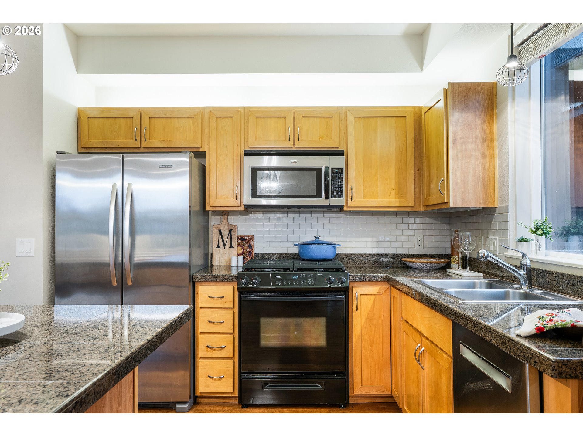 347 Rustic Place, Unit 14 Eugene, OR 97401 - Photo 17 of 20 a kitchen with stainless steel appliances granite countertop a stove a sink and a microwave