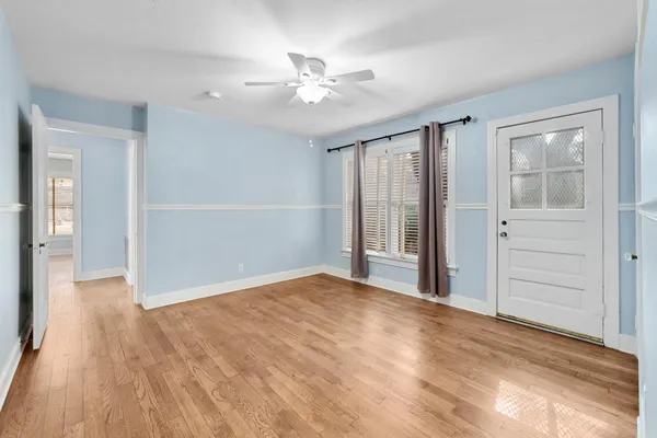 wooden floor in an empty room with a window