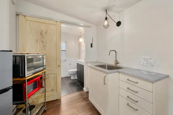 a en suite bathroom with a granite countertop sink and a mirror