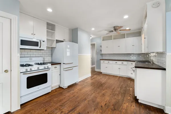 a kitchen with stainless steel appliances a stove a sink and a refrigerator