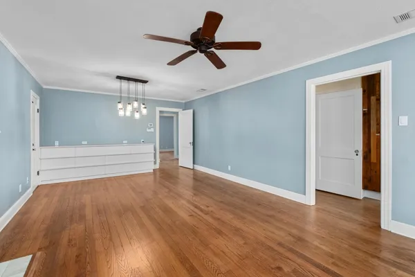 a view of room with wooden floor and ceiling fan