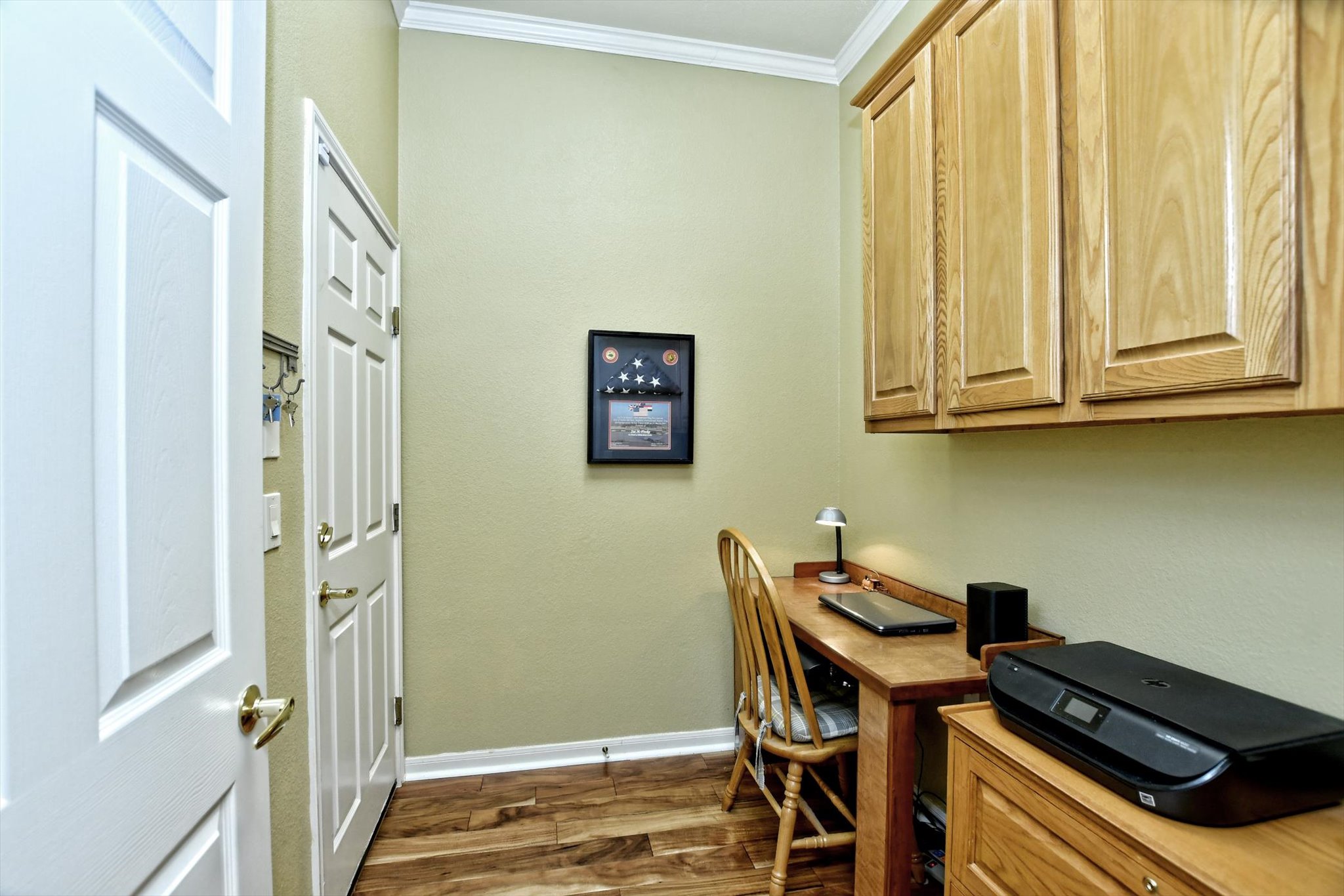 106 Nighthawk Way Georgetown, TX 78633 - Photo 13 of 29 Functional office space features ample cabinetry and rich wood flooring.
