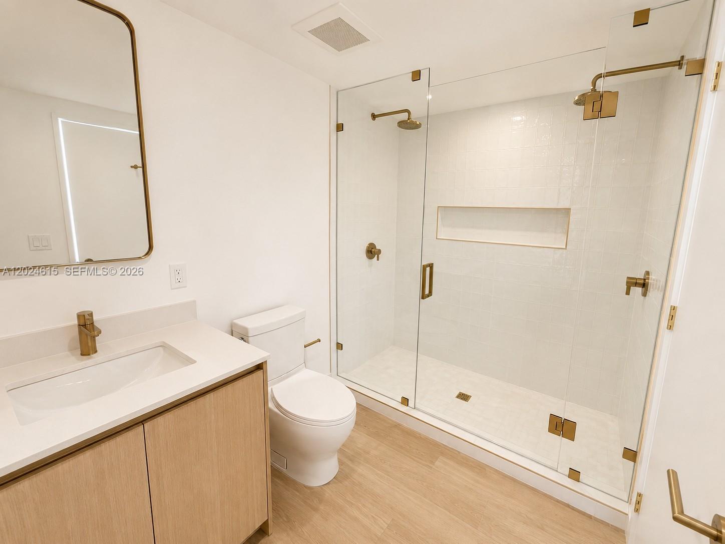 90 Northeast 32nd Street, Unit 301 Miami, FL 33127 - Photo 6 of 21 a bathroom with a sink a toilet and shower