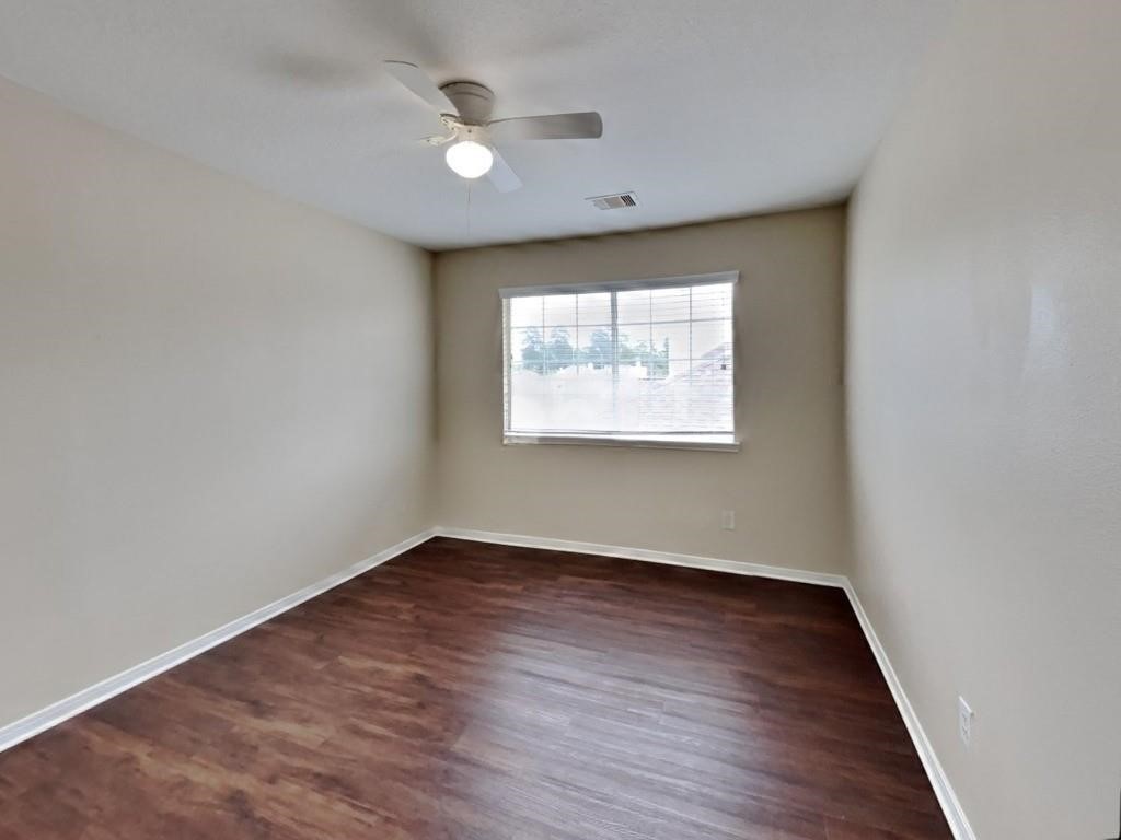 439 Pinewood Ridge Drive Spring, TX 77386 - Photo 17 of 18 an empty room with wooden floor and windows