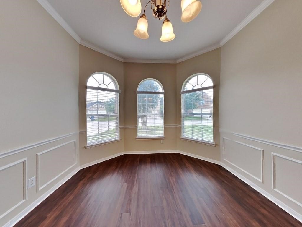 439 Pinewood Ridge Drive Spring, TX 77386 - Photo 7 of 18 a view of an empty room with wooden floor and a window