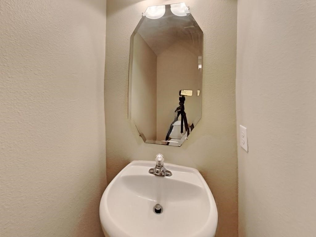 439 Pinewood Ridge Drive Spring, TX 77386 - Photo 9 of 18 a bathroom with a sink and mirror