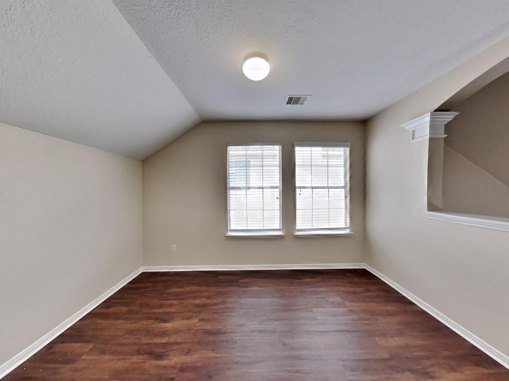 439 Pinewood Ridge Drive Spring, TX 77386 - Photo 10 of 18 an empty room with wooden floor and windows