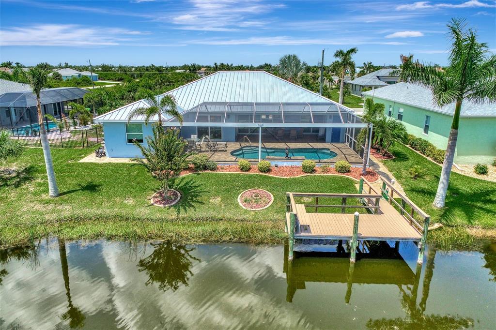 Back of the elegant Home with heated pool and Dock