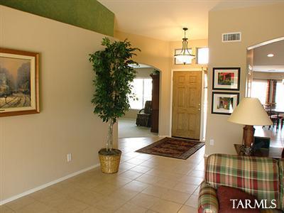 62195 East Northwood Road Tucson, AZ 85739 - Photo 4 of 25 a living room with a couch and a potted plant