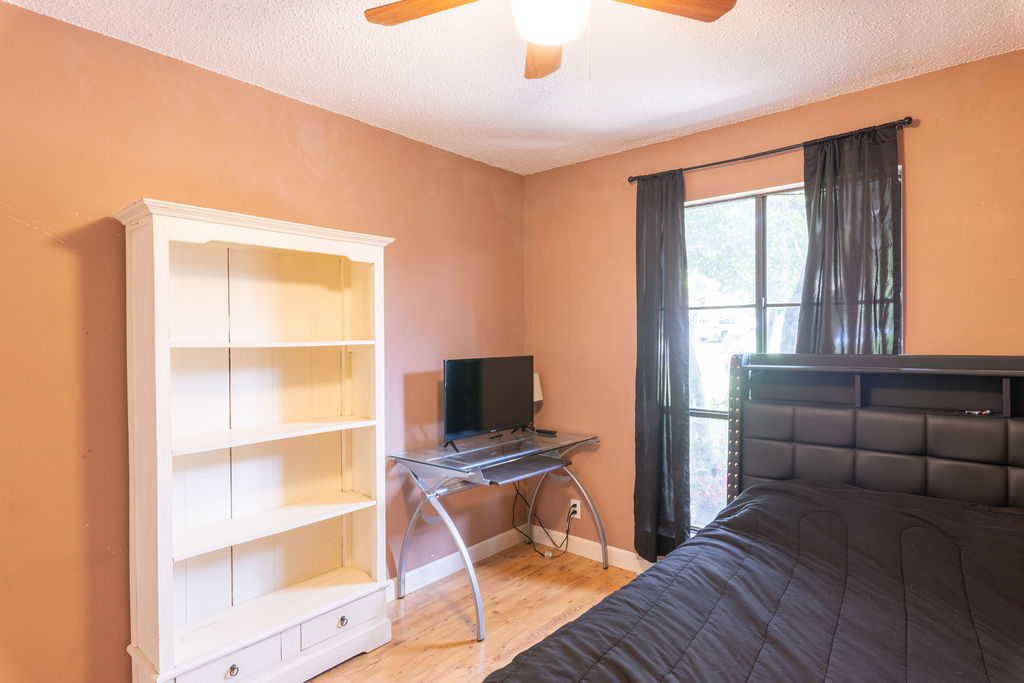 5310 Presidio Road Austin, TX 78745 - Photo 19 of 34 Hardwood flooring extends throughout this well-lit bedroom, offering ample space and natural light.