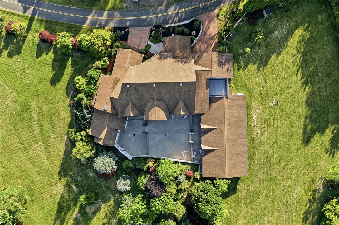 6271 Batman Road Zionsville, PA 18092 - Photo 98 of 100 An aerial perspective reveals a sprawling estate set against a backdrop of green lawns and dense, mature landscaping.