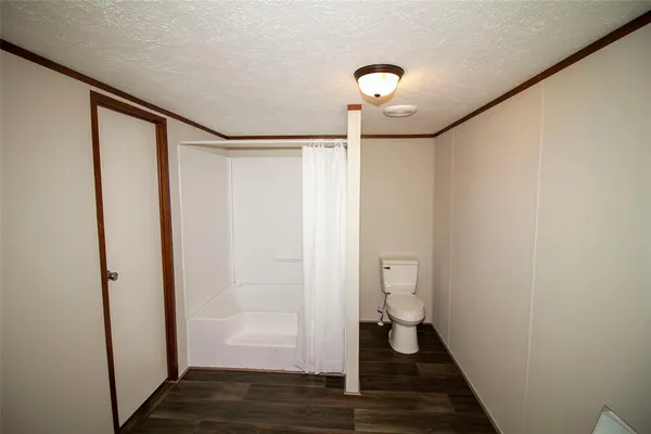 a view of a room with a fan and a shower
