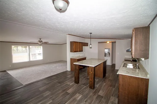 a kitchen with stainless steel appliances granite countertop a sink a stove and a refrigerator