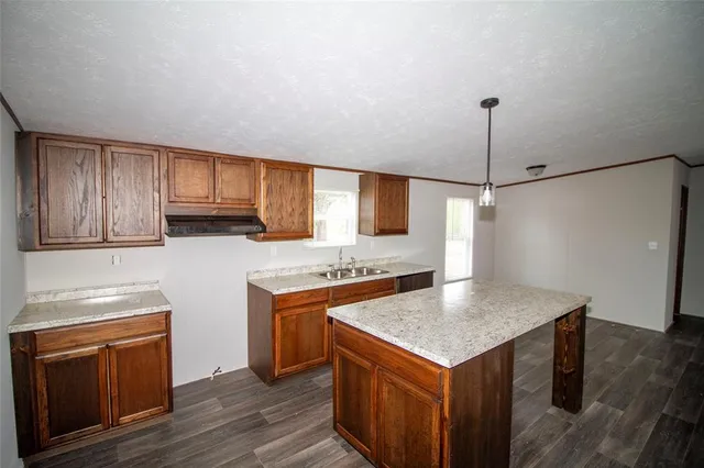 a kitchen with sink cabinets and window