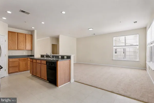a large kitchen with stainless steel appliances granite countertop a stove and a sink