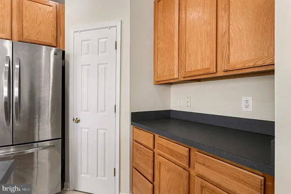 a kitchen with a refrigerator and cabinets
