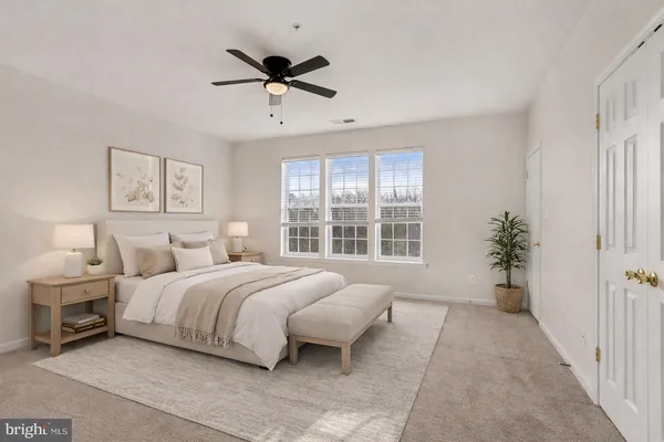 a spacious bedroom with a bed and a window