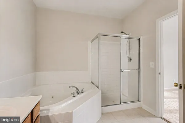a bathroom with a tub a sink and vanity