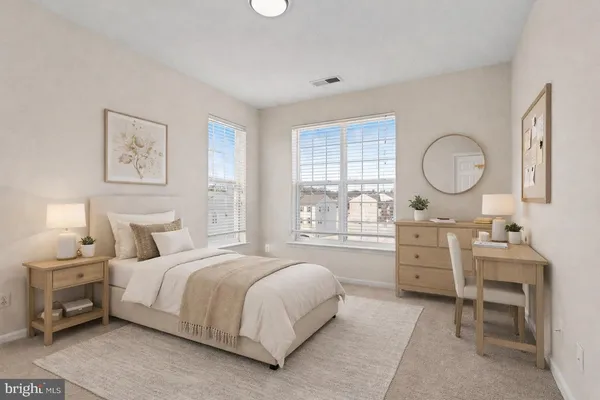 a bedroom with a bed and a dresser