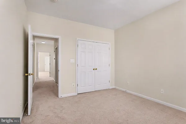 a view of an empty room and closet