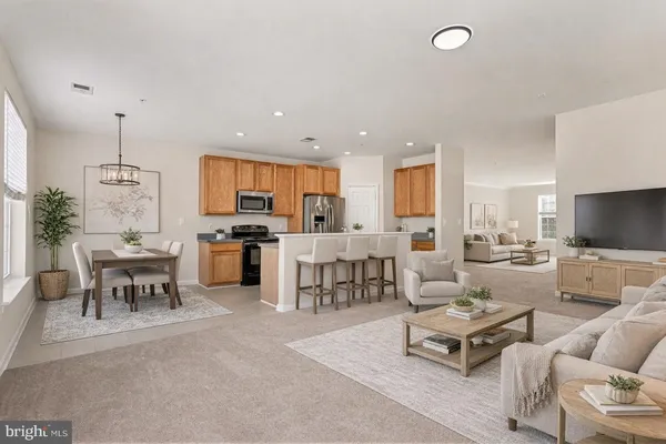 a living room with lots of furniture kitchen view and a chandelier
