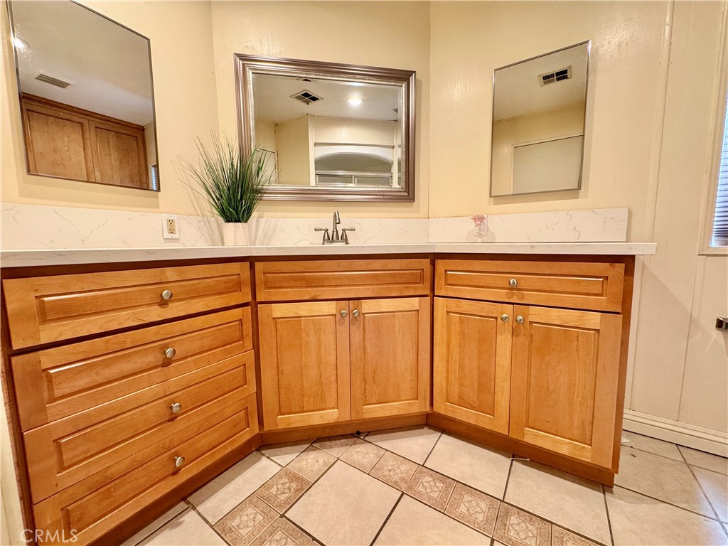23301 Ridge Rte Drive, Unit 109 Laguna Hills, CA 92653 - Photo 27 of 46 a bathroom with a sink and a mirror