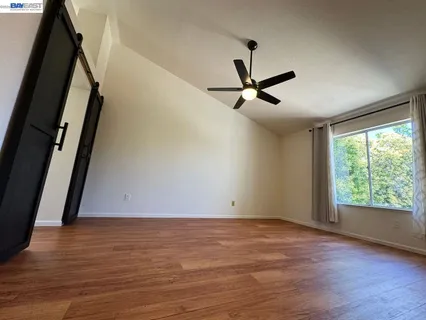 a spacious bathroom with a toilet a sink and mirror