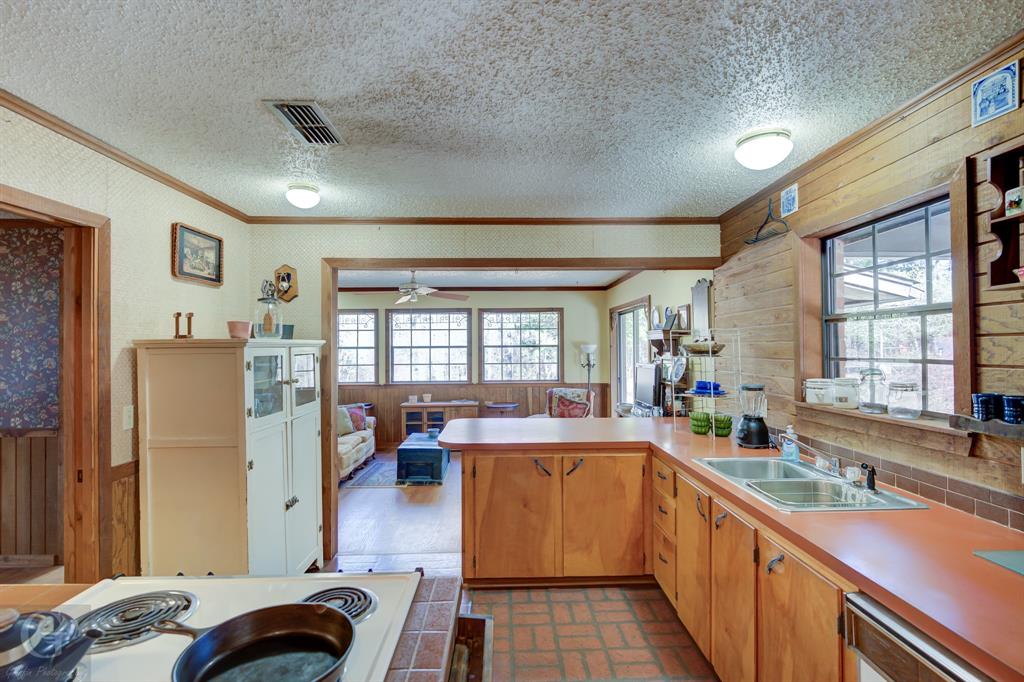 7105 Rodessa Ida Road Ida, LA 71044 - Photo 5 of 40 a kitchen filled with stainless steel appliances granite countertop a refrigerator a sink dishwasher a stove and a dining table with wooden cabinet