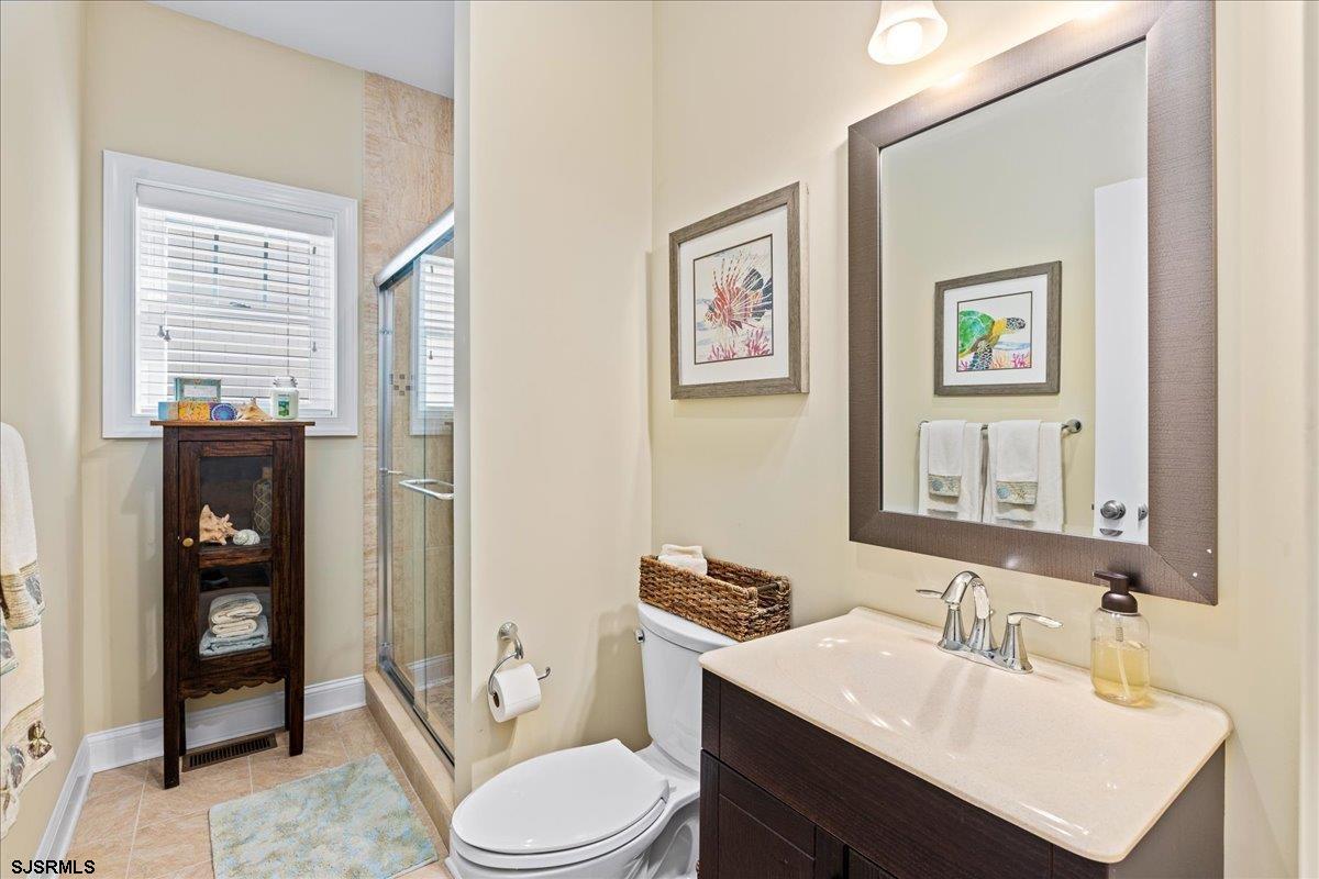16 South Decatur Avenue, Unit A Margate City, NJ 08402 - Photo 20 of 51 a bathroom with a toilet a sink and mirror