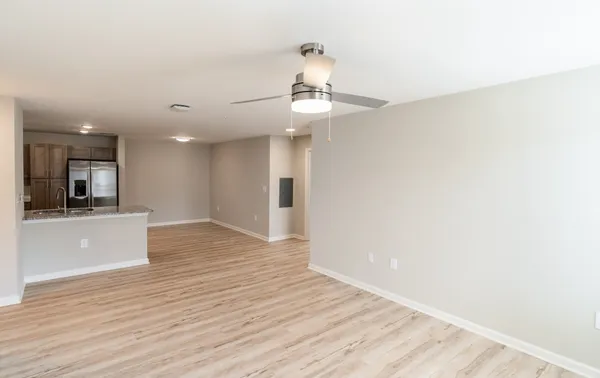 a kitchen with stainless steel appliances granite countertop a refrigerator a stove a sink and a microwave