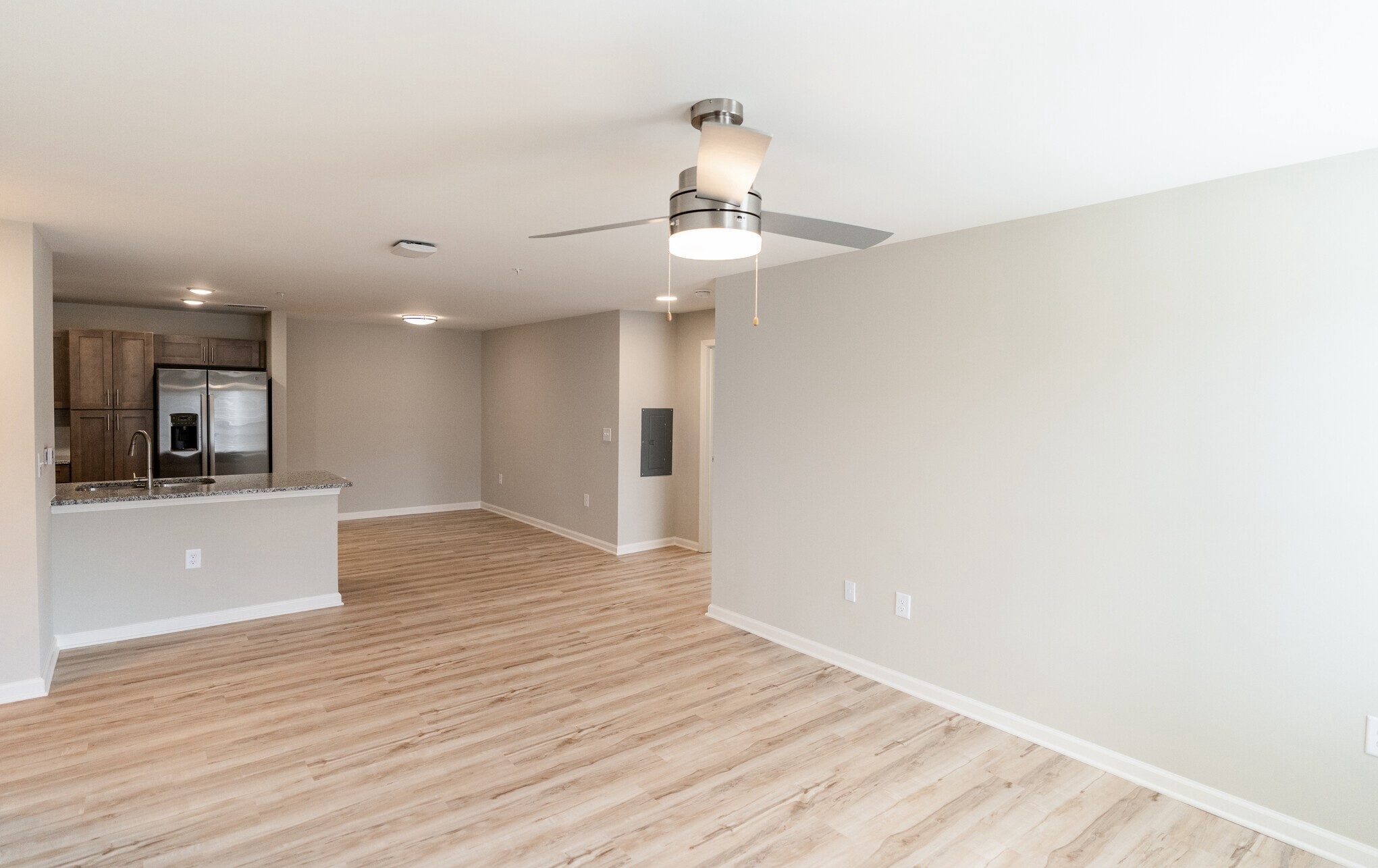 3432 Carr Road Durham, NC 27703 - Photo 11 of 28 a view of a kitchen with wooden floor and a ceiling fan