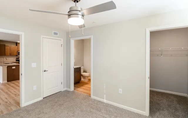 a view of a hallway with wooden floor and closet